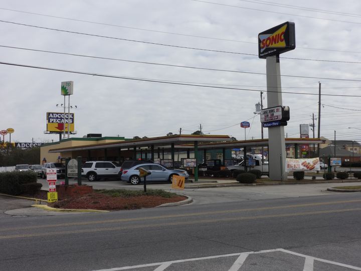 A Sonic drive-in with covered parking stalls and menu boards