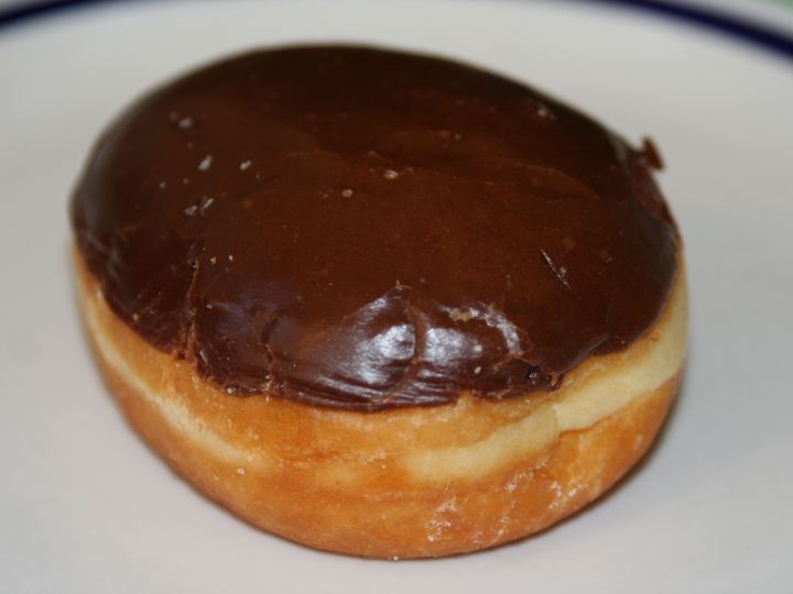 A Boston cream doughnut with chocolate icing