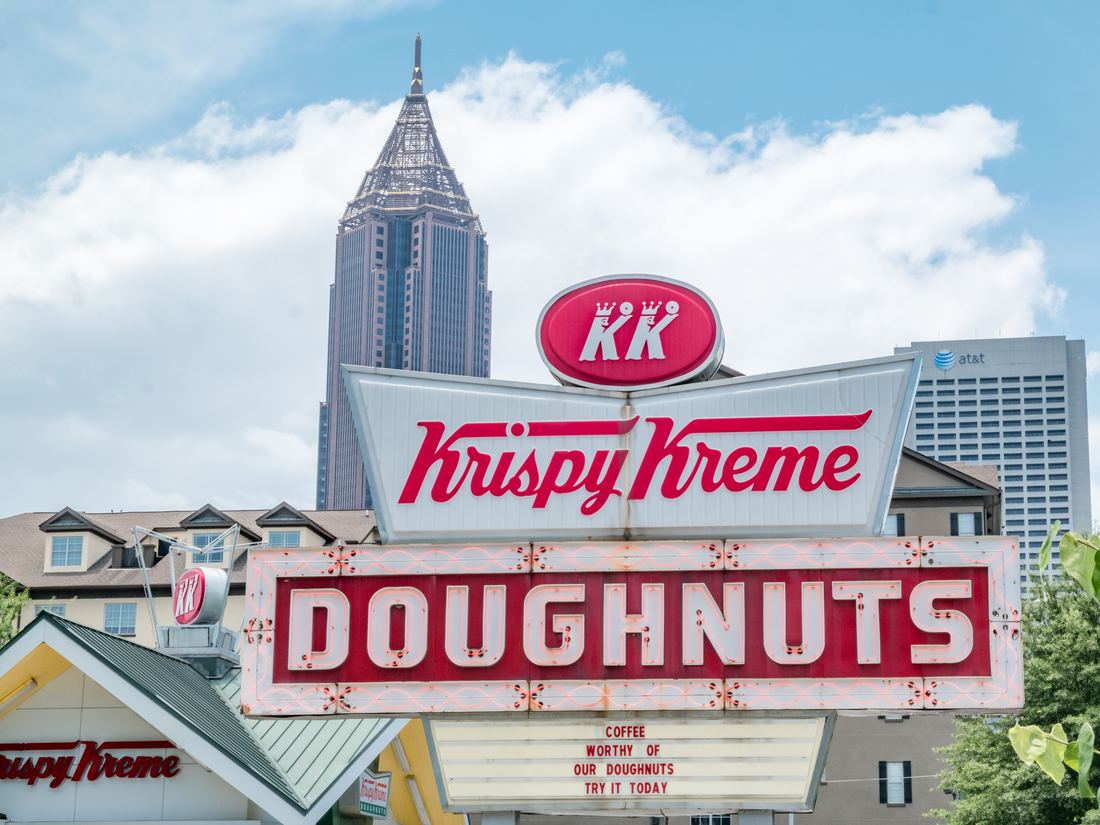 A neon doughnut shop sign in Atlanta at night