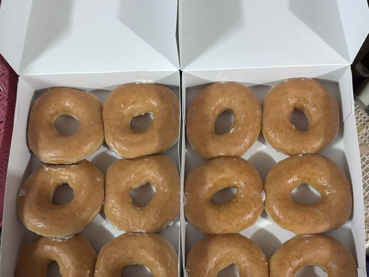 A shiny Krispy Kreme original glazed doughnut