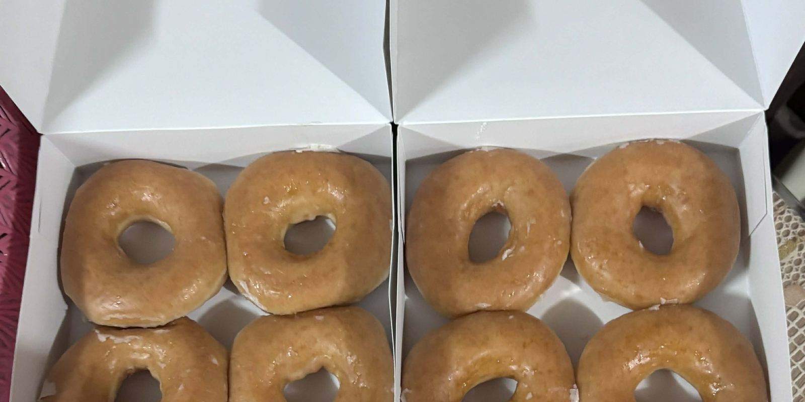 A shiny Krispy Kreme original glazed doughnut