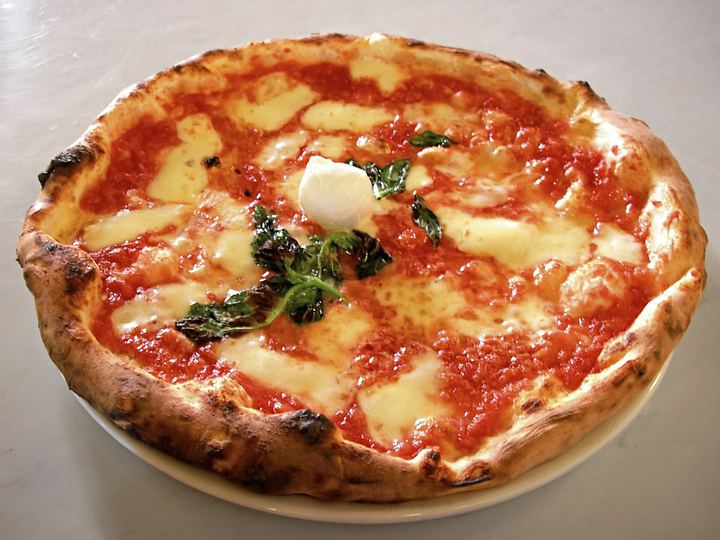 A Neapolitan pizza margherita with tomato, mozzarella and basil
