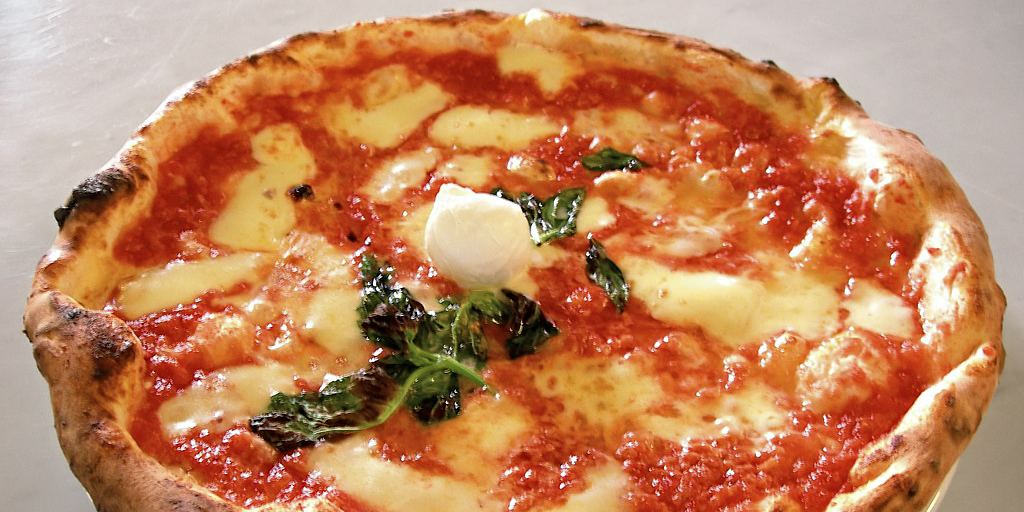 A Neapolitan pizza margherita with tomato, mozzarella and basil